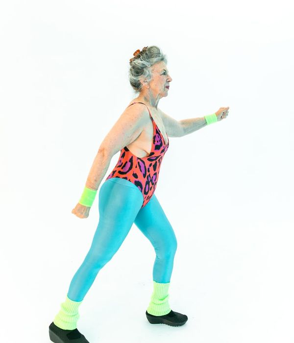 Smiling woman in activewear feeling energetic after a workout.